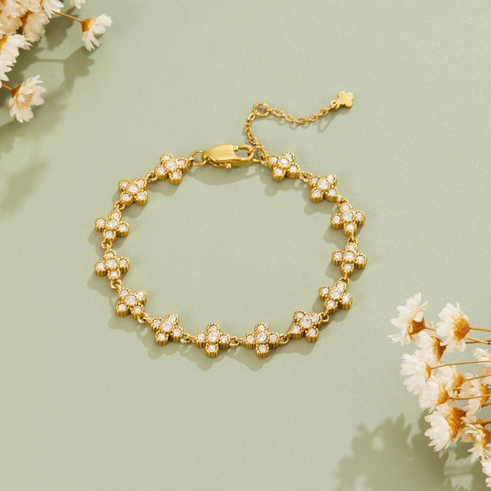 Crystal Blossom Clustered Bracelet, laid flat on sage green with dried white flowers around it